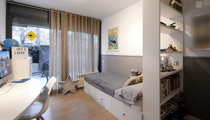 La chambre a un lit et une commode